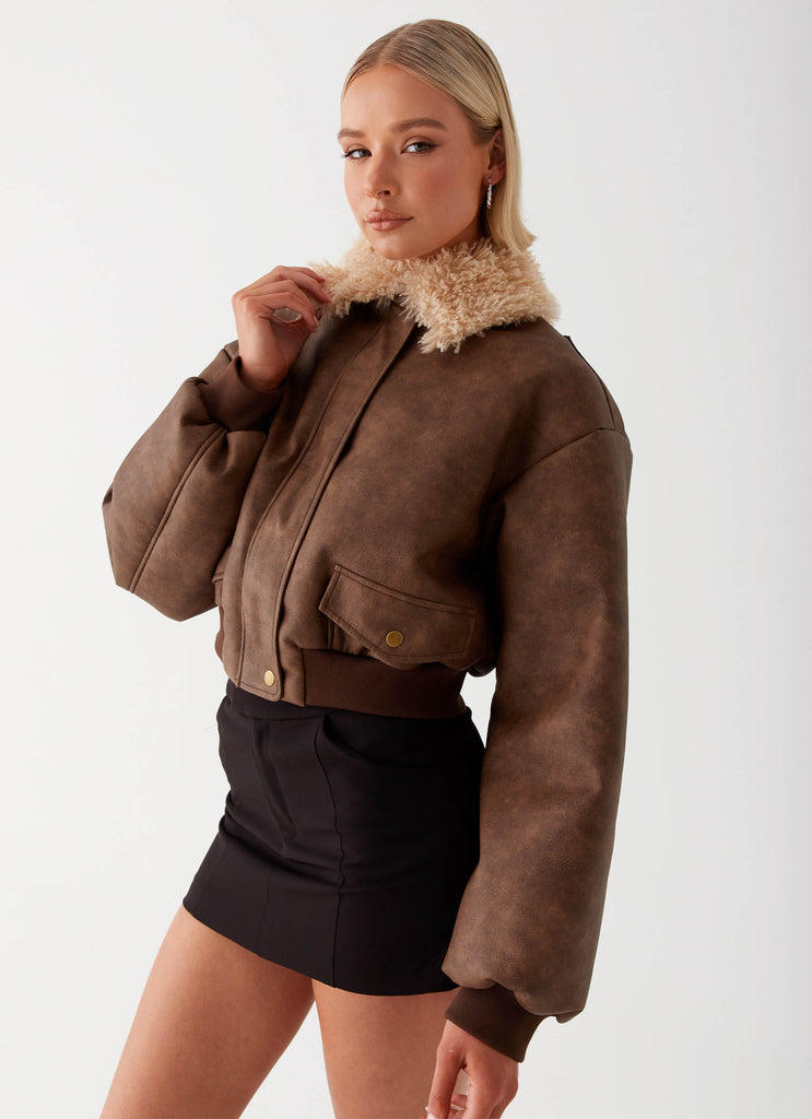 Womens Aston Shearling Bomber Jacket in the colour Brown in front of a light grey background