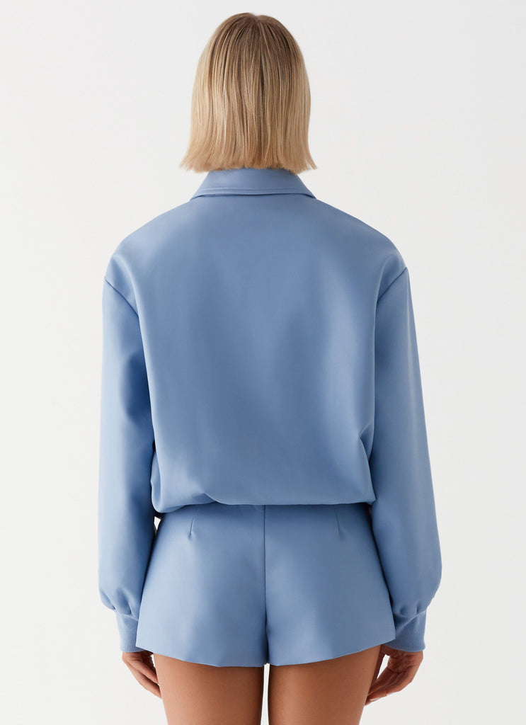 Womens Aspen Oversized Bomber Jacket in the colour Blue in front of a light grey background