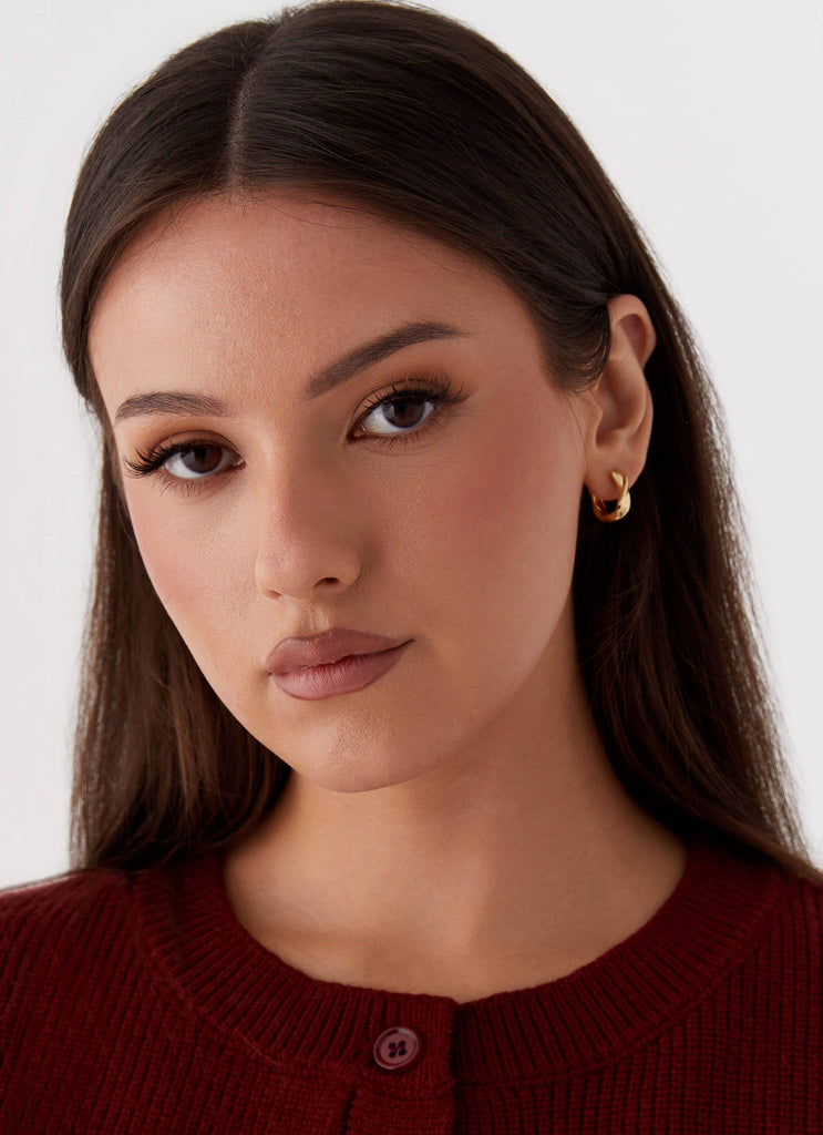 Womens Jacquie Hoop Earrings in the colour Gold in front of a light grey background