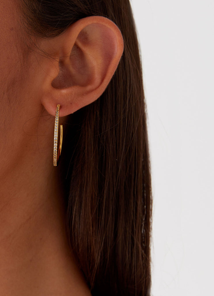 Womens Lilyanna Earrings in the colour Gold in front of a light grey background