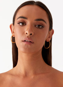 Womens Lilyanna Earrings in the colour Gold in front of a light grey background