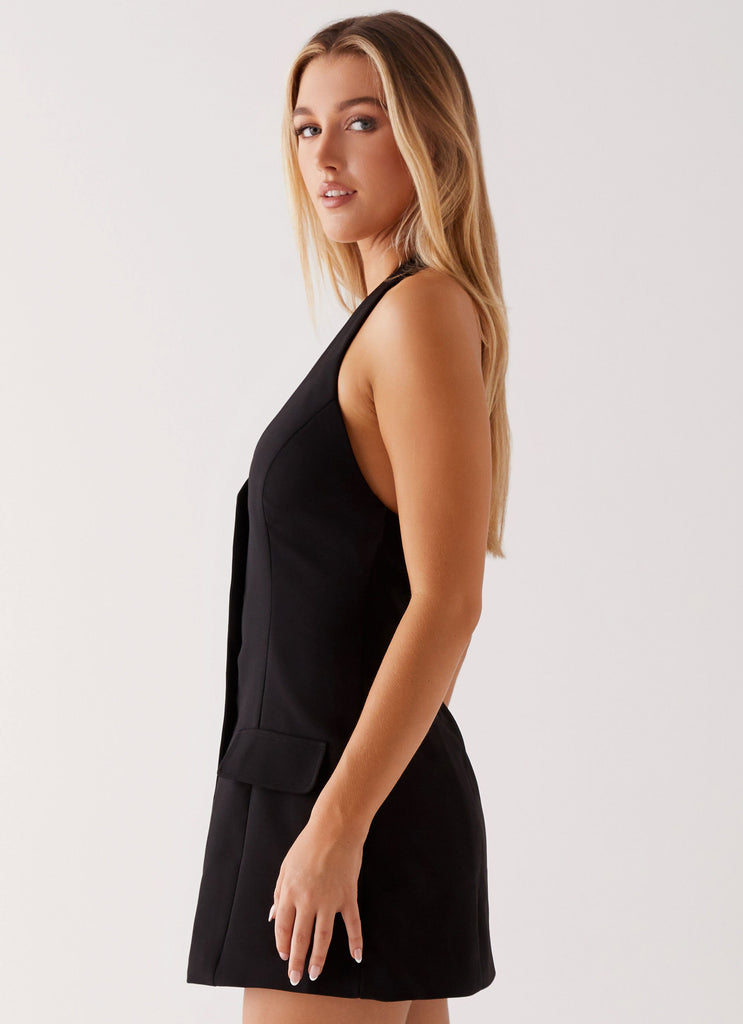 Womens Mira Halter Neck Mini Dress in the colour Black in front of a light grey background