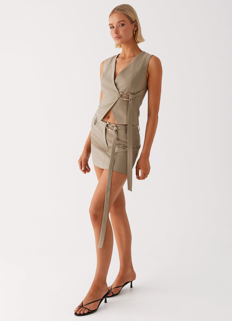 Womens Mira Mini Skirt in the colour Khaki in front of a light grey background