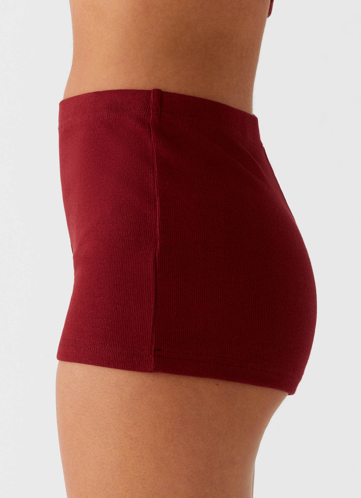 Womens Spectate Mini Shorts in the colour Maroon in front of a light grey background