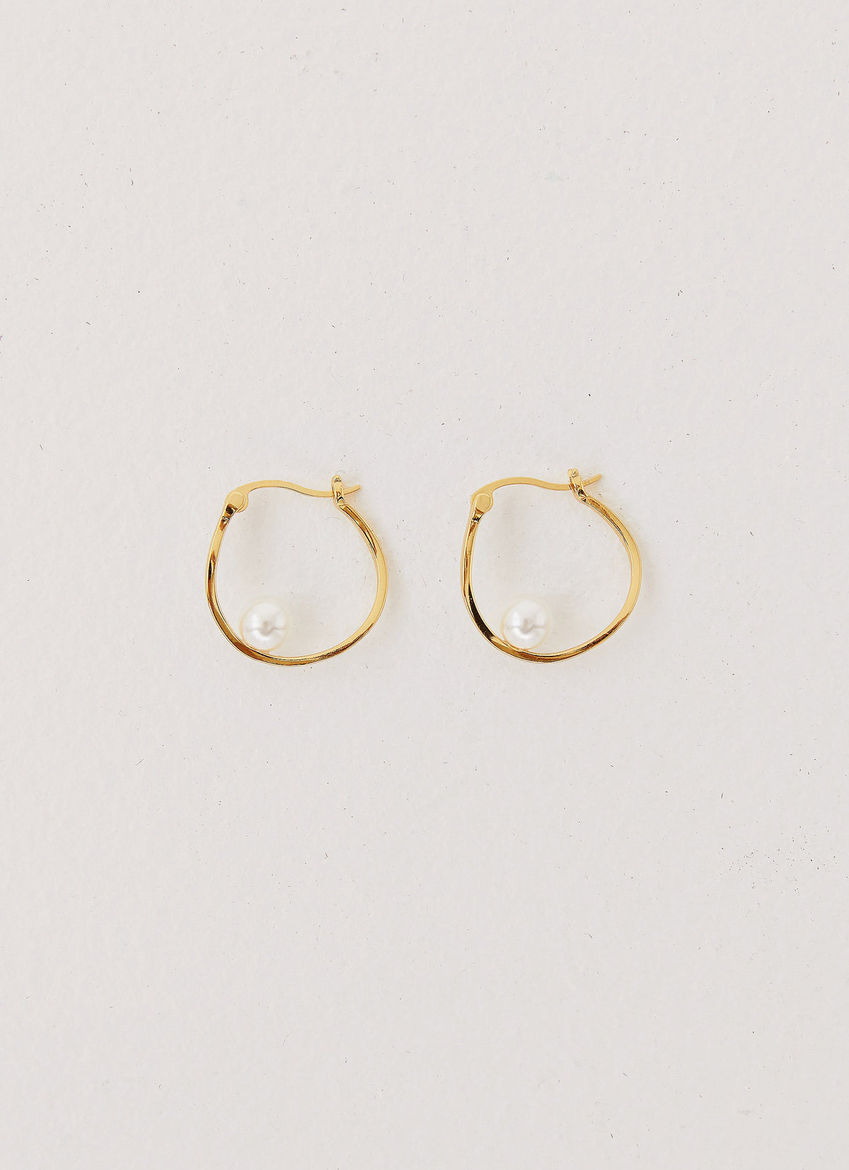 Womens Cosima Abstract Hoop Earring in the colour Gold in front of a light grey background