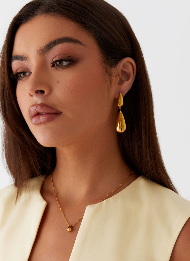 Womens Stay True Earrings in the colour Gold in front of a light grey background