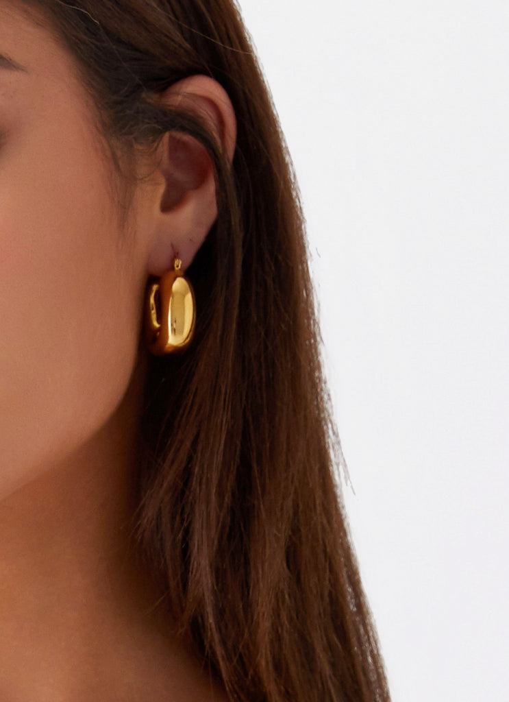 Womens Sweet Distraction Earrings in the colour Gold in front of a light grey background