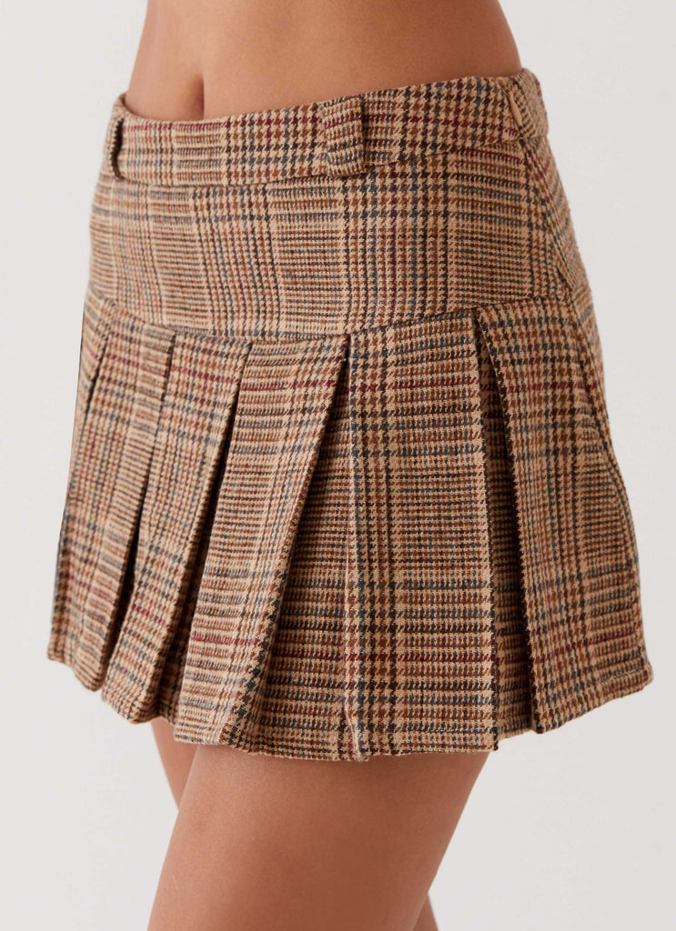 Womens Danica Pleated Mini Skirt in the colour Brown Check in front of a light grey background