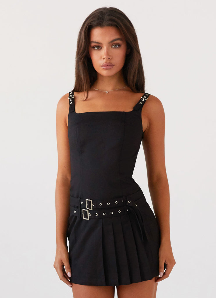 Womens Lynette Buckle Mini Dress in the colour Black in front of a light grey background