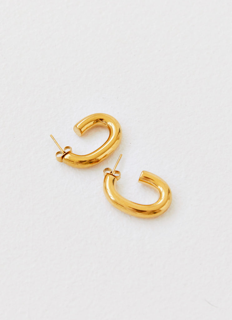 Womens Stardust Hoop Earrings in the colour Gold in front of a light grey background