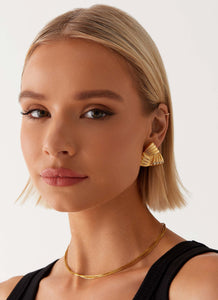 Womens Unholy Earrings in the colour Gold in front of a light grey background